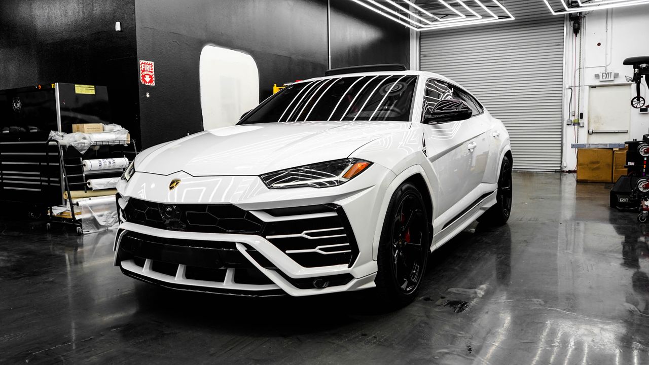 services-03 White luxury SUV in a sleek garage, showcasing modern design and premium automotive style.